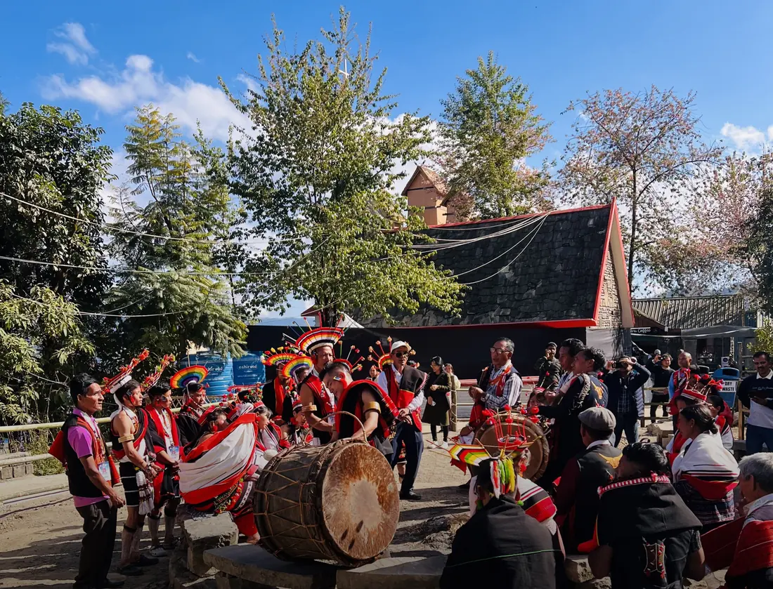 Naga performers around a log drum at Hornbill Festival