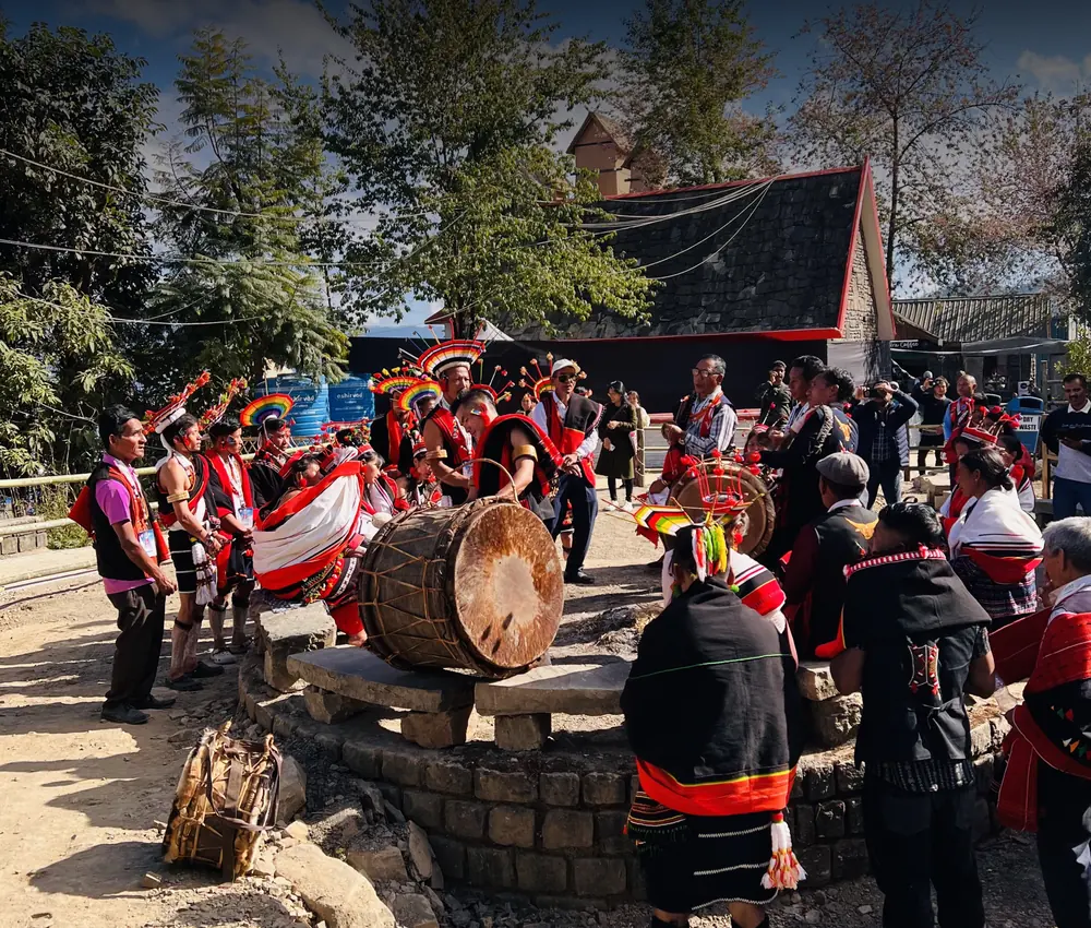 Dancers and drummers in a Naga morung courtyard